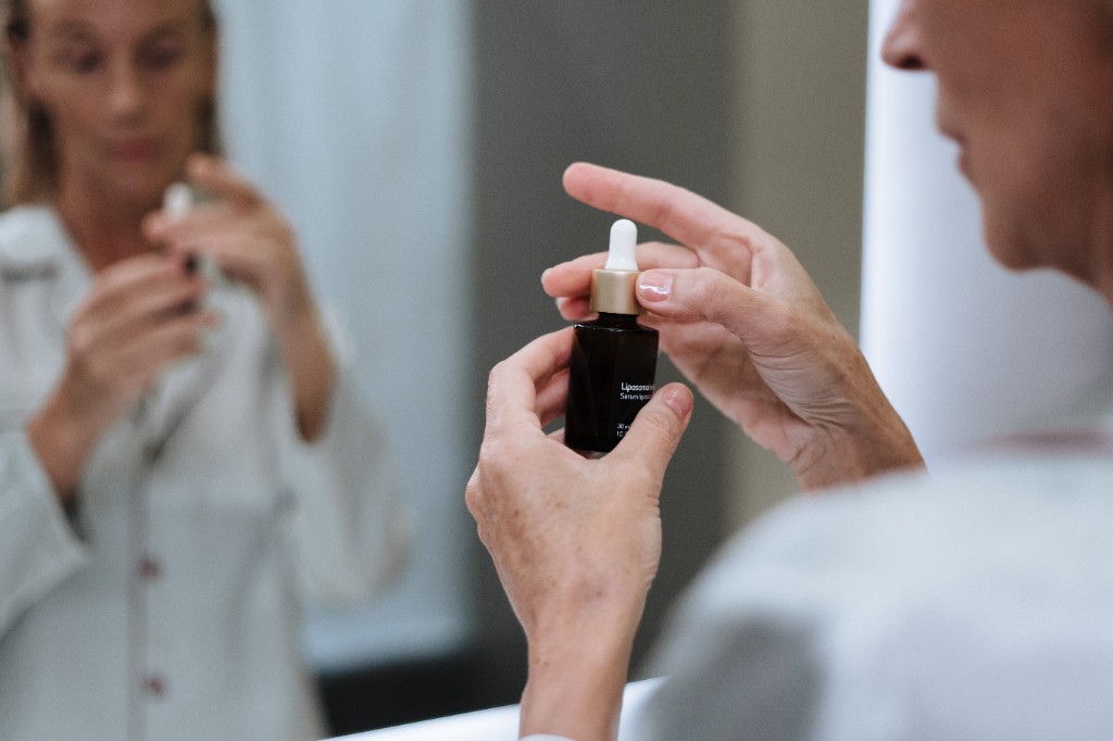 Woman applying serum as part of a daily skincare routine